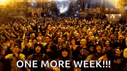 A Large Crowd Of People With The Words One More Week In The Corner GIF