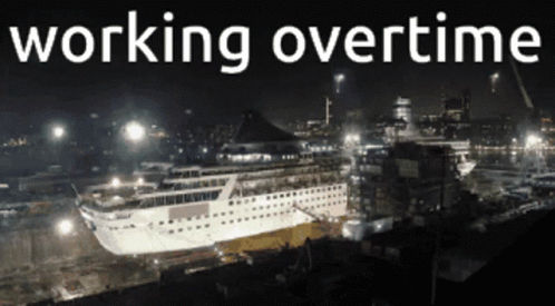 A Large Cruise Ship Is Being Built At Night And The Words Working Overtime Are Above It GIF