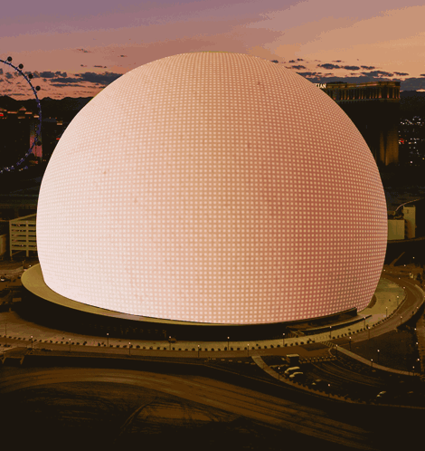 A Large Dome With A Lot Of Lights On It Is Lit Up At Night GIF