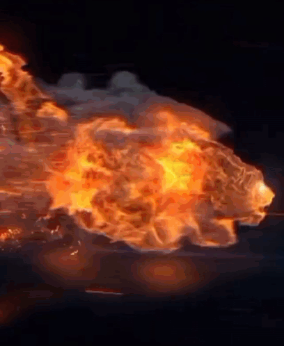 A Large Explosion With A Lot Of Fire Coming Out Of It . GIF