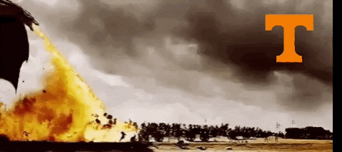 A Large Fire Is Being Thrown In The Air With The Letter T Above It GIF