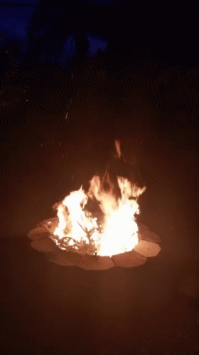 A Large Fire Is Burning In A Dark Area GIF