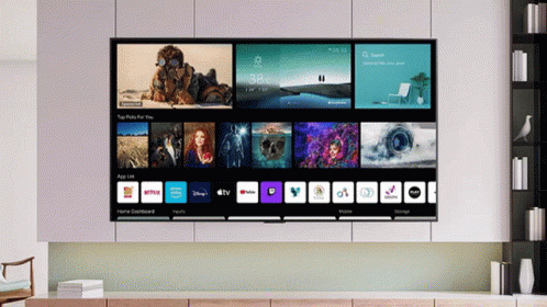 A Large Flat Screen Tv Is Displaying A Home Dashboard With Apps Like Netflix And Youtube GIF