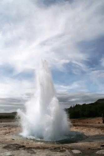 A Large Geyser Is Erupting In The Middle Of A Desert GIF