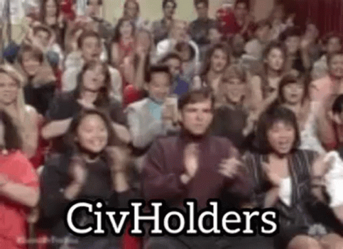 A Large Group Of People Are Clapping And Applauding In A Room . GIF