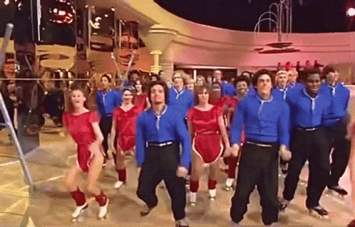 A Large Group Of People Are Dancing In A Room GIF