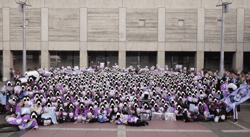 A Large Group Of People Are Posing For A Picture In Front Of A Large Building GIF