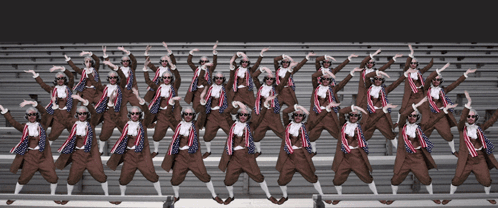 A Large Group Of People Wearing Sunglasses Are Standing In A Row GIF