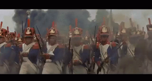 A Large Group Of Soldiers Are Marching In A Line With Their Guns In Their Hands . GIF
