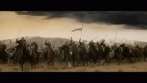 A Large Group Of Soldiers Are Riding Horses Through A Desert . GIF