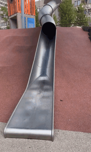 A Large Metal Slide Is Going Down A Red Carpet GIF