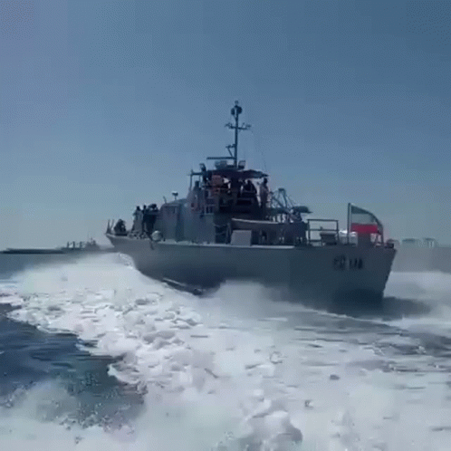 A Large Military Ship Is Going Through The Ocean GIF