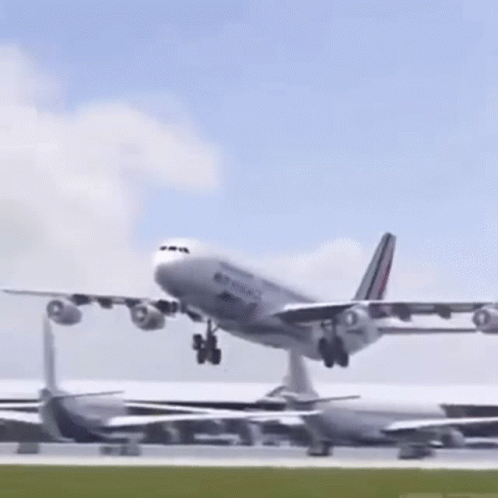 A Large Passenger Jet Is Taking Off From A Runway At An Airport . GIF