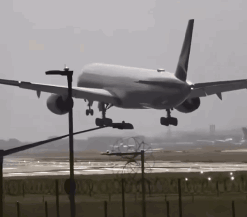 A Large Passenger Jet Is Taking Off From A Runway GIF