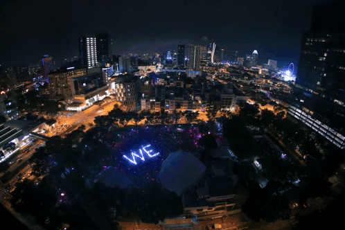 A Large Purple Ready Sign Is Lit Up In A City GIF