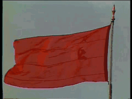 A Large Red Flag With A Hammer And Sickle On It Is Flying In The Wind GIF