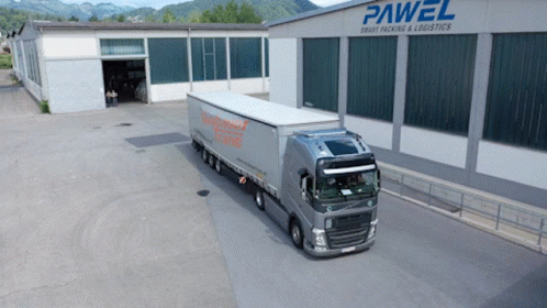 A Large Truck Is Parked In Front Of A Building That Says Pawel GIF