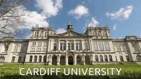 A Large White Building With The Words Cardiff University Written On It GIF