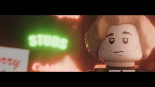 A Lego Character Is Standing In Front Of A Neon Sign That Says Studs GIF