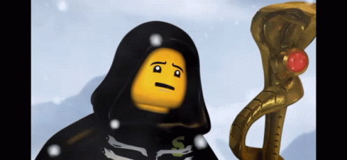 A Lego Figure With A Black Cape And A Yellow Face Is Standing Next To A Gold Snake GIF