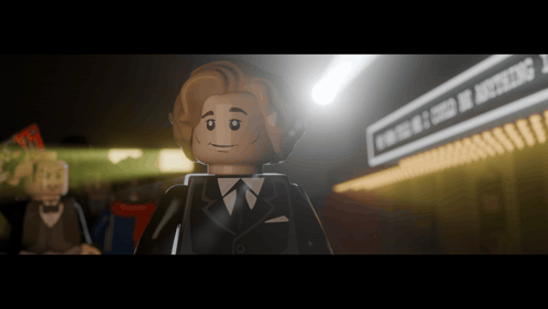 A Lego Man In A Suit And Tie Stands In Front Of A Sign That Says Evening Of Excellence GIF