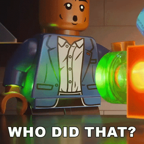 A Lego Man In A Suit Is Standing Next To A Green Object That Says Who Did That On It GIF
