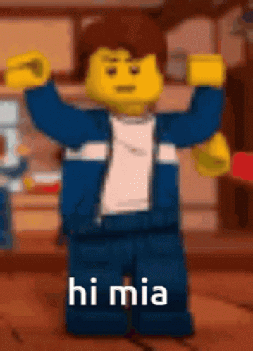 A Lego Man Is Standing With His Arms In The Air And Says Hi Mia . GIF