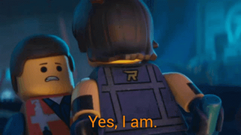 A Lego Man Says " Yes I Am " While Wearing A Vest With The Letter A On It GIF