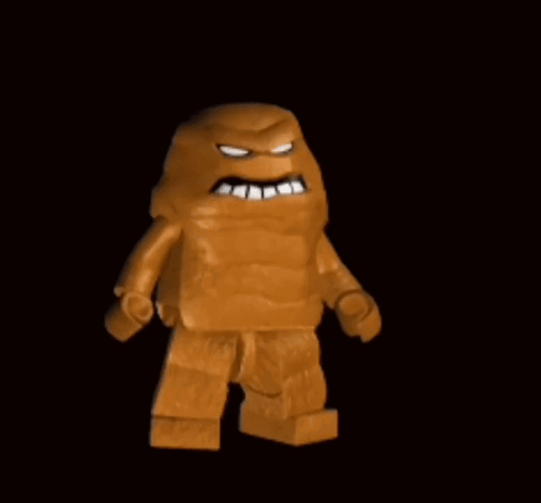 A Lego Man With A Huge Mouth Is Standing In The Dark . GIF