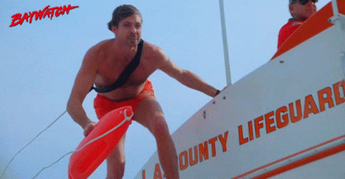 A Lifeguard Is Standing On A Boat That Says Bounty Lifeguard On It GIF