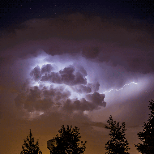 A Lightning Bolt Strikes A Cloud In The Sky GIF