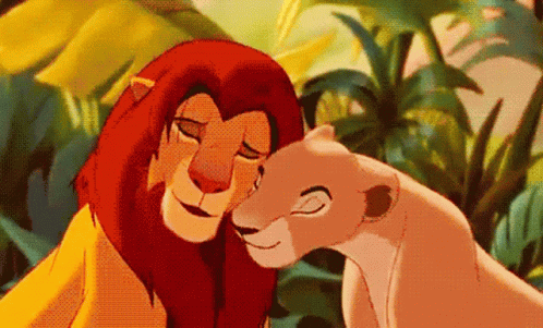 A Lion And A Lioness From The Lion King Are Hugging Each Other In The Jungle . GIF