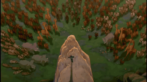 A Lion Is Sitting On Top Of A Rocky Cliff GIF