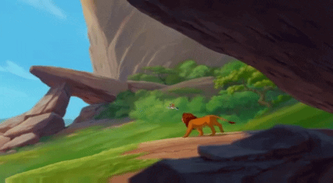 A Lion Is Walking Down A Dirt Path In The Jungle GIF