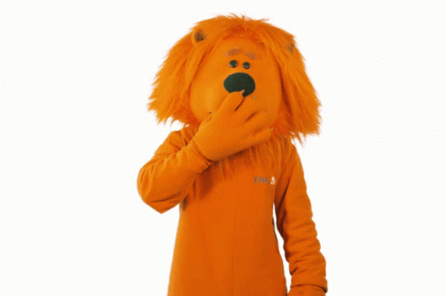 a lion mascot covering his mouth with his hand while wearing an orange sweater that says nb