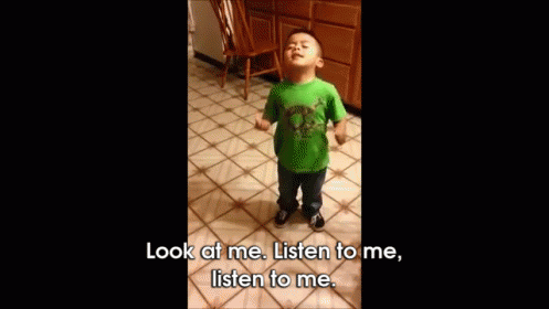 A Little Boy In A Green Shirt Is Standing On A Tiled Floor And Says Look At Me Listen To Me Listen To Me GIF