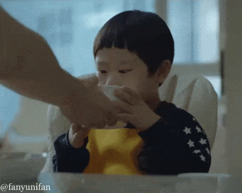 A Little Boy In A High Chair Is Being Fed By A Person With The Hashtag Fanyunifan GIF