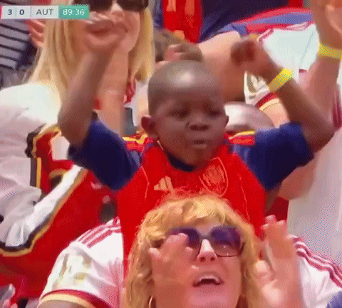 A Little Boy In A Red Adidas Shirt Is Sitting On A Woman 'S Shoulders GIF