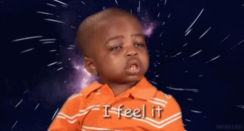 A Little Boy In An Orange Shirt Is Crying And Saying `` I Feel It '' In Front Of A Space Background . GIF