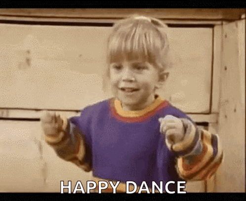 A Little Boy Is Dancing And Pointing At The Camera With The Words `` Happy Dance '' Written Below Him . GIF