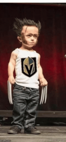 A Little Boy Is Dressed As Wolverine And Is Holding Claws GIF