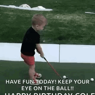 A Little Boy Is Playing Golf With A Golf Club On A Green . GIF