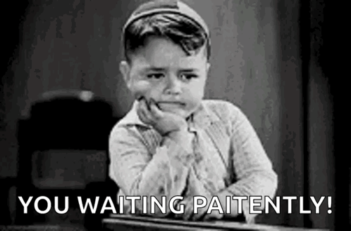 A Little Boy Is Sitting At A Desk With His Hand On His Chin And The Words `` You Waiting Patiently '' . GIF