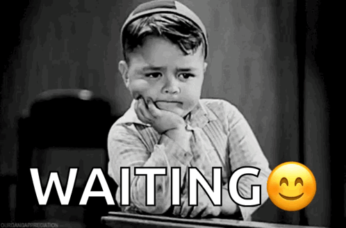 A Little Boy Is Sitting At A Desk With The Word Waiting Written On It GIF