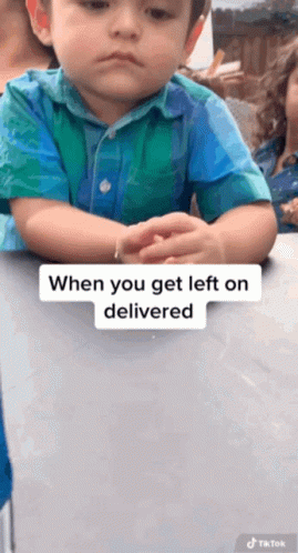 A Little Boy Is Sitting At A Table With His Arms Crossed And A Caption That Says " When You Get Left On Delivered " GIF