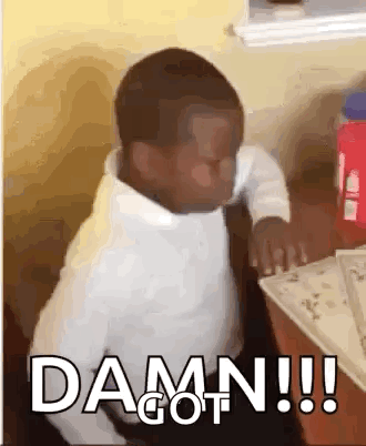 A Little Boy Is Sitting At A Table With The Words `` Damn !!! '' Written On The Screen . GIF