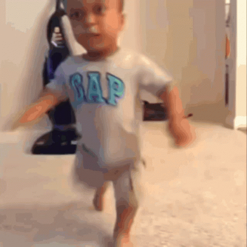 A Little Boy Wearing A Gap Shirt Is Running GIF