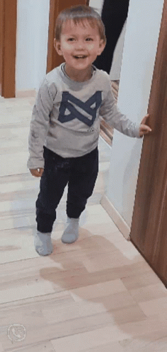 A Little Boy Wearing A Gray Shirt With The Letter A On It GIF