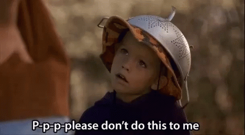 A Little Boy Wearing A Hat Made Out Of A Strainer Is Talking To Someone . GIF