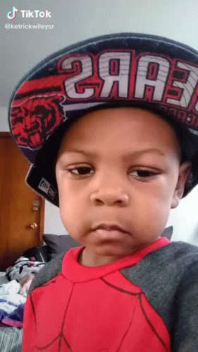 A Little Boy Wearing A Hat That Says 2Aa3 On It GIF